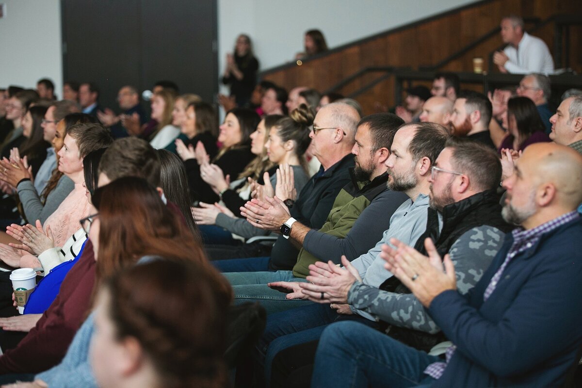 a-diverse-audience-clapping-and-engaged-in-a-corporate-conference-session-in-indianapolis