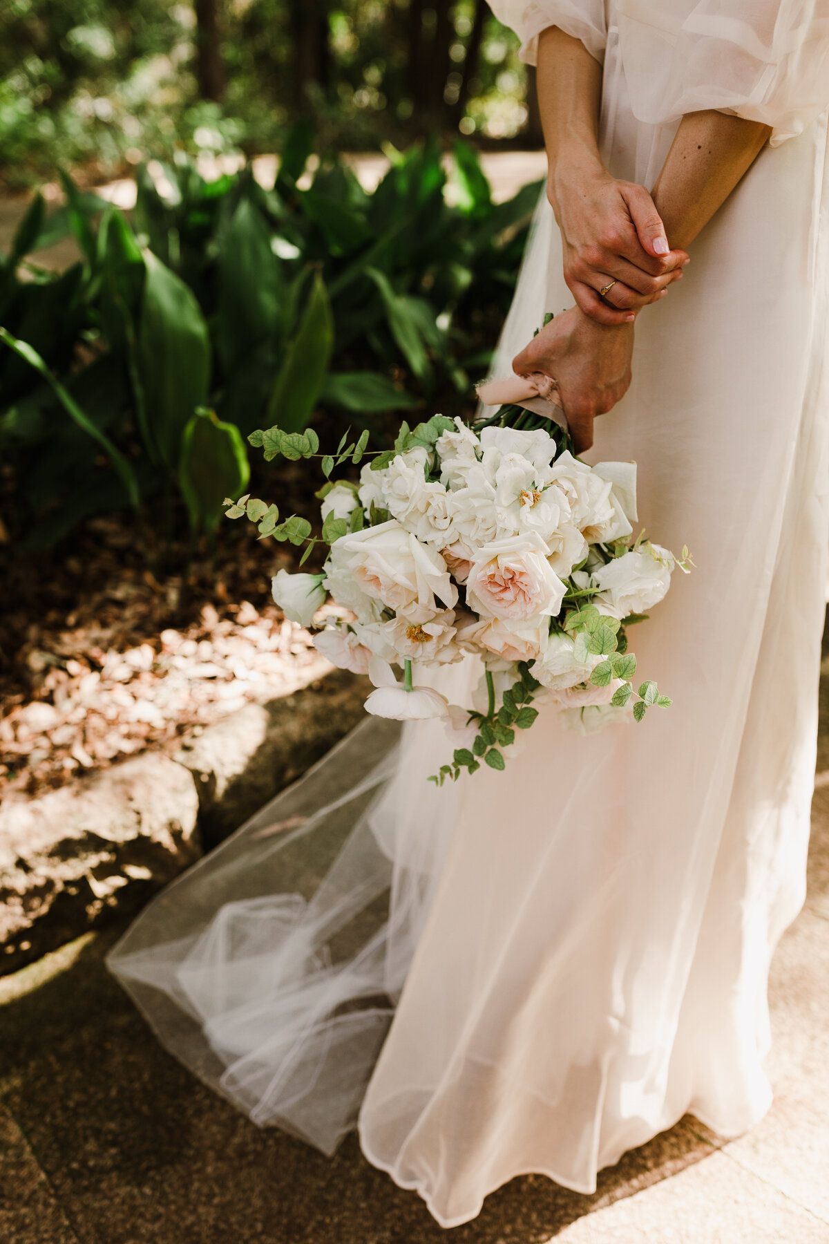 Bride holding bouquet of white florals