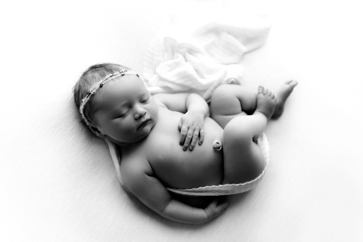 Black and white shadow image of baby on a blanket in trussville alabama newborn photography studio