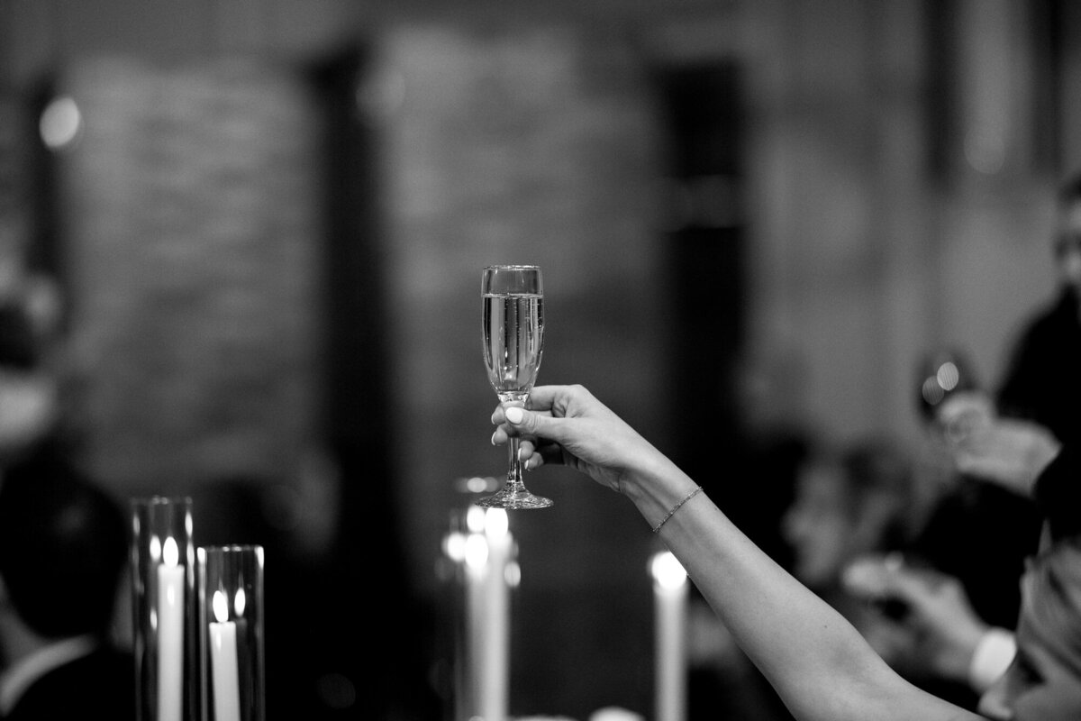 Wedding guest raising glass during reception