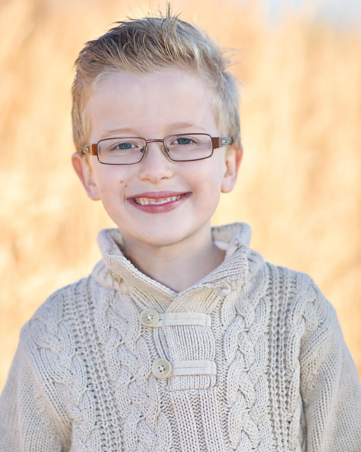 Cute actor headshot of a young boy in a sweater.