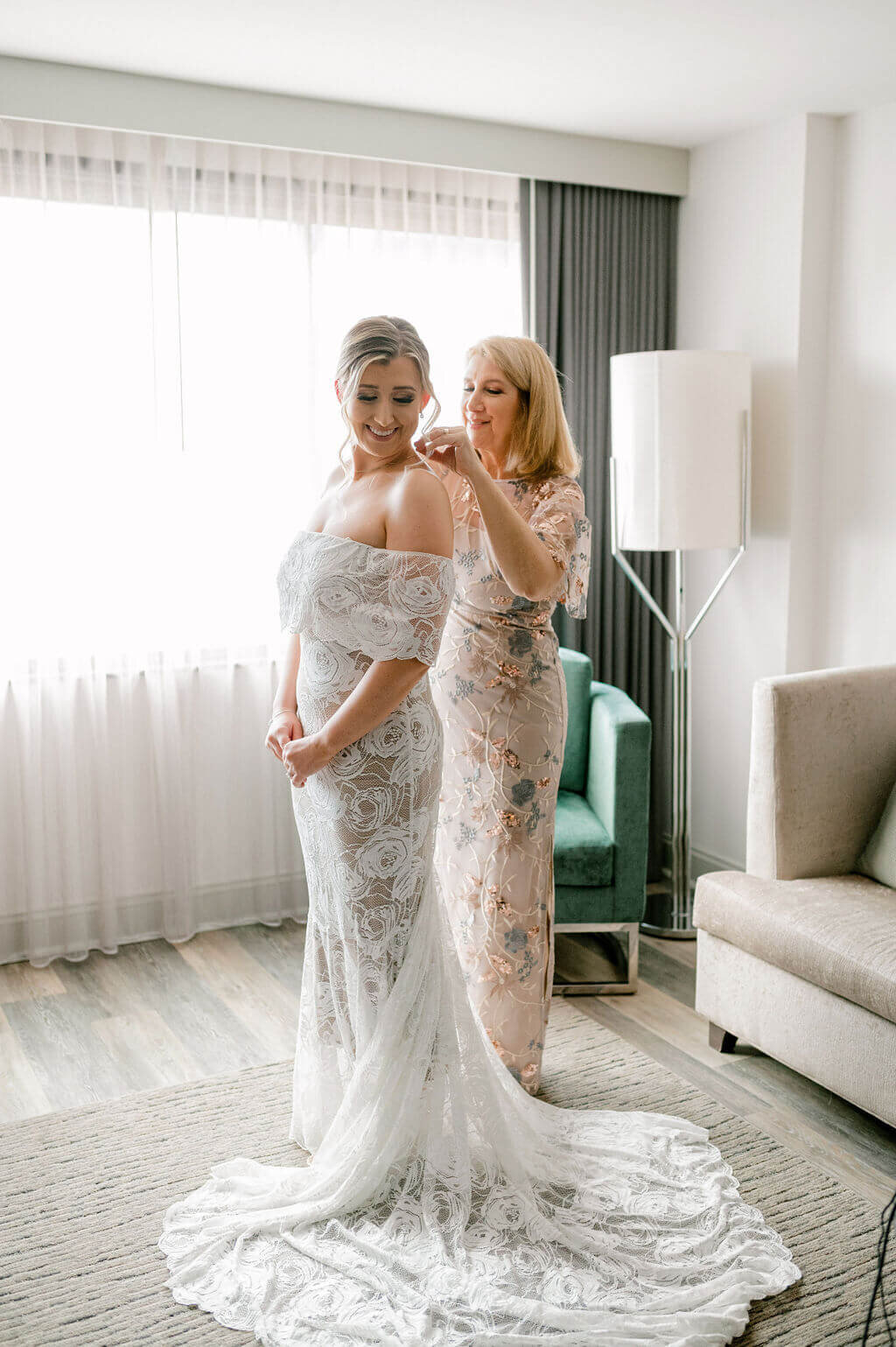 Mother of bride zipping bride into her Grace Loves Lace gown , captured by Rachael Mattio Photography