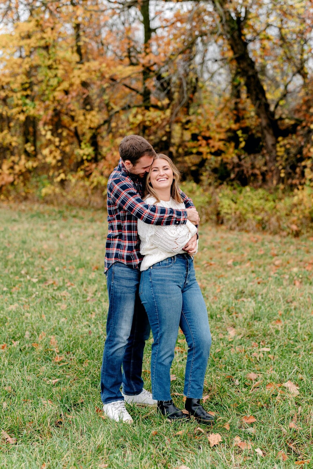 man-embracing-bride-to-be-fall-engagement