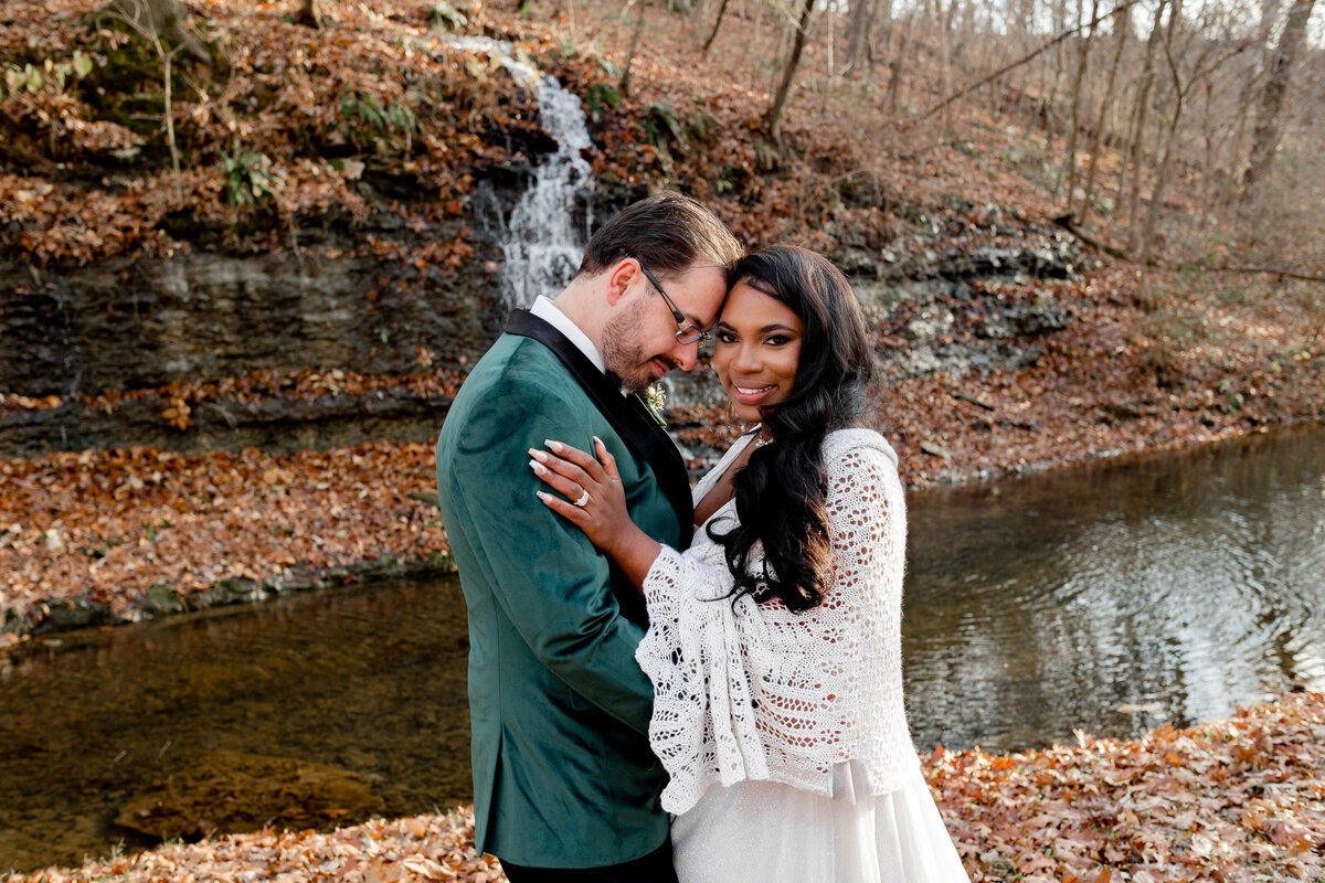 Stunning 'Mr. and Mrs.' portraits captured by Style & Grace Photography in Arkansas, with a breathtaking waterfall backdrop, showcasing the couple’s love in a natural and romantic setting.