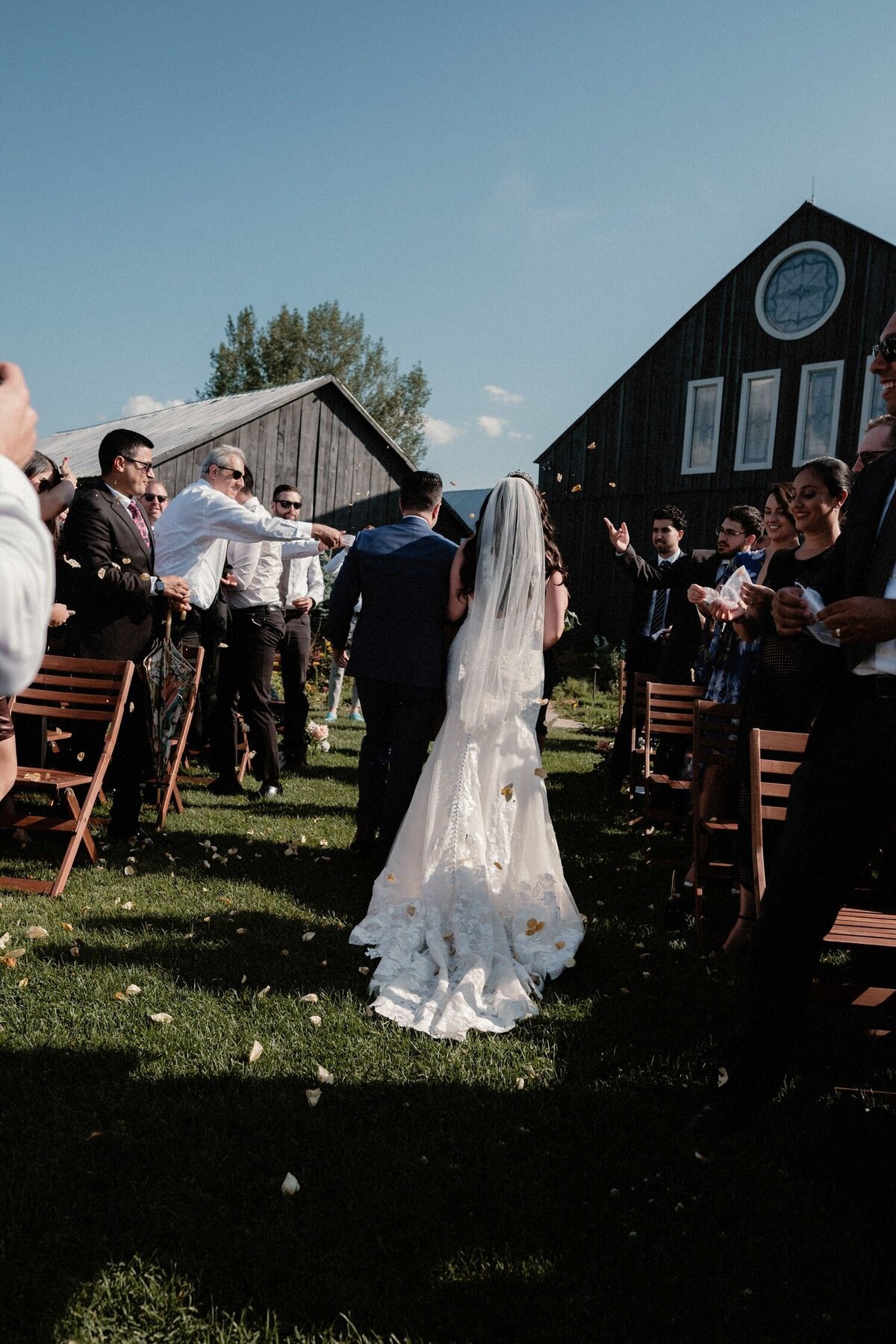 recessional with flowers thrown by guests for newlyweds