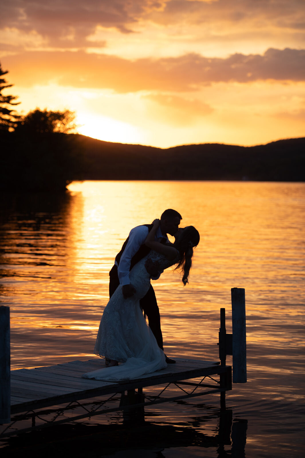 lake bomoseen lodge sunset couple silhouette kissing on dock