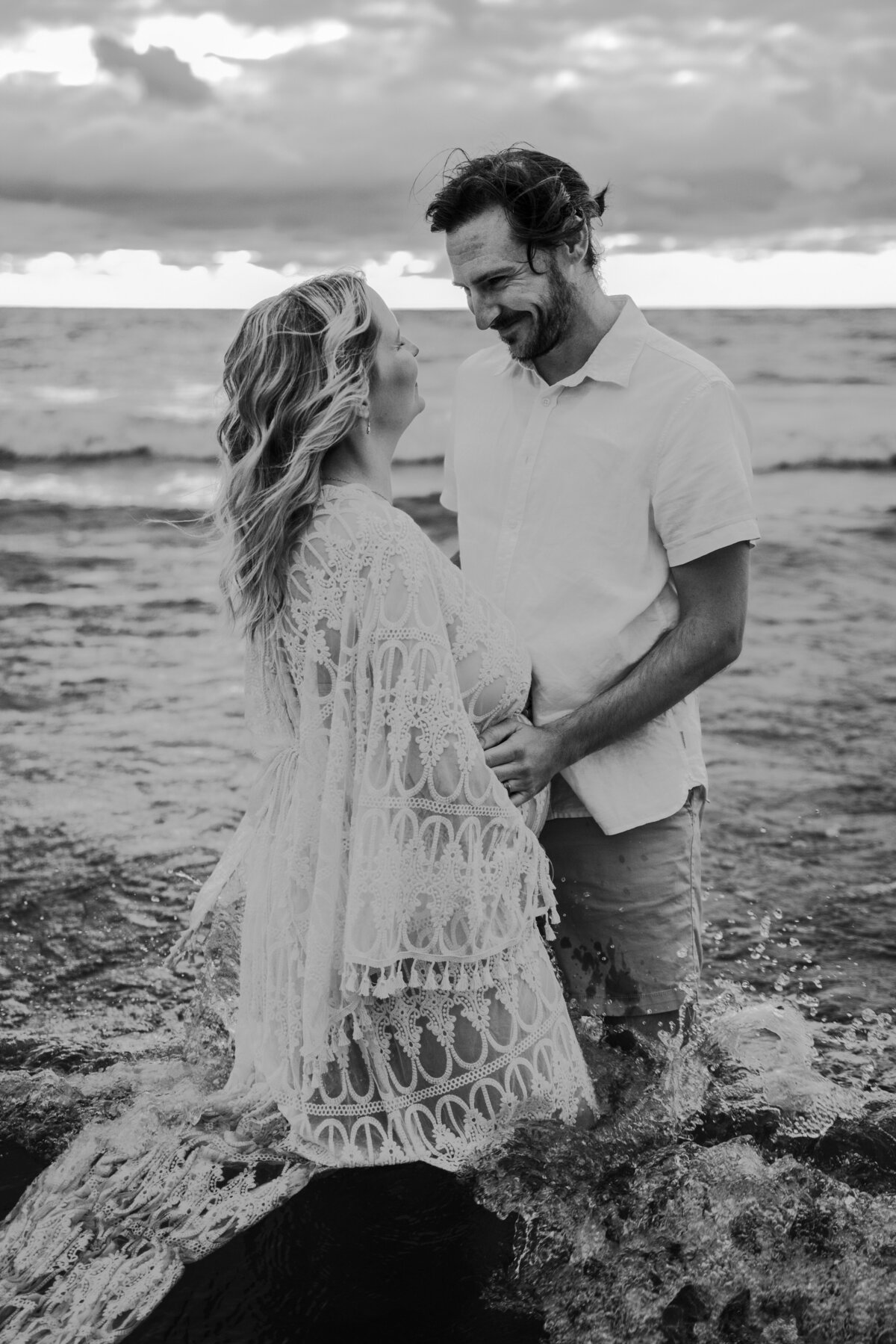 black and white photo of  pregnant mother with dad in the waters of lake ontario