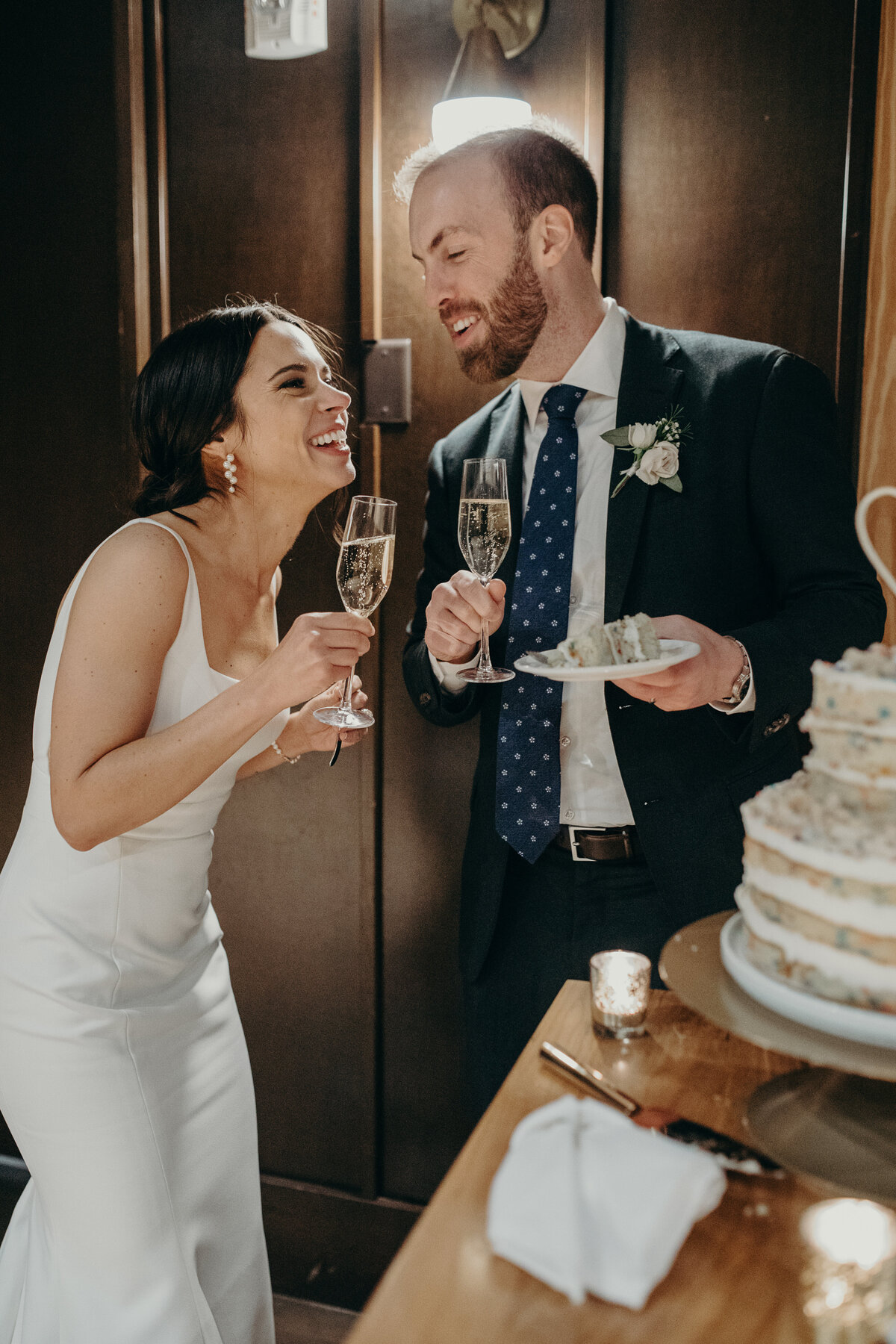 Bride and groom toasting with champagne at their reception.