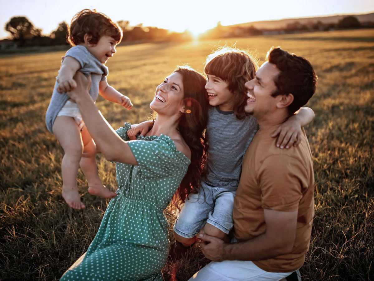 Family of four posing by the during golden hour mini session in york, PA