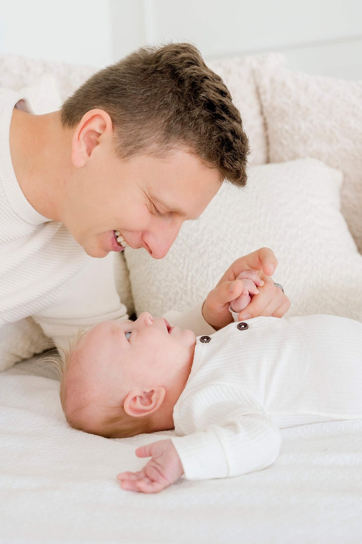 A happy family enjoys a modern, white studio photography experience, courtesy of Alexandra Robyn Photo + Design