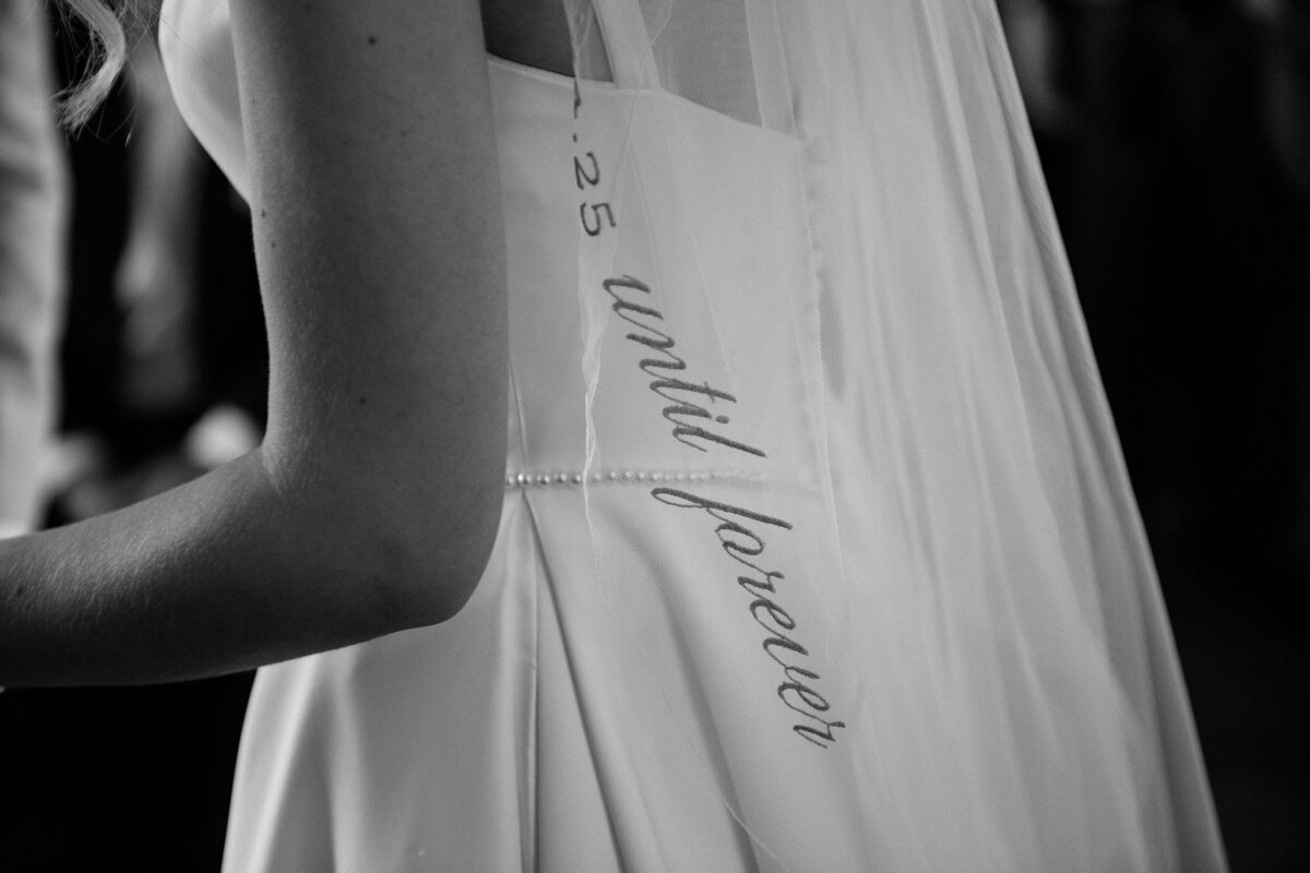 Black and white image of embroidered veil with wedding date at Thicket Priory York