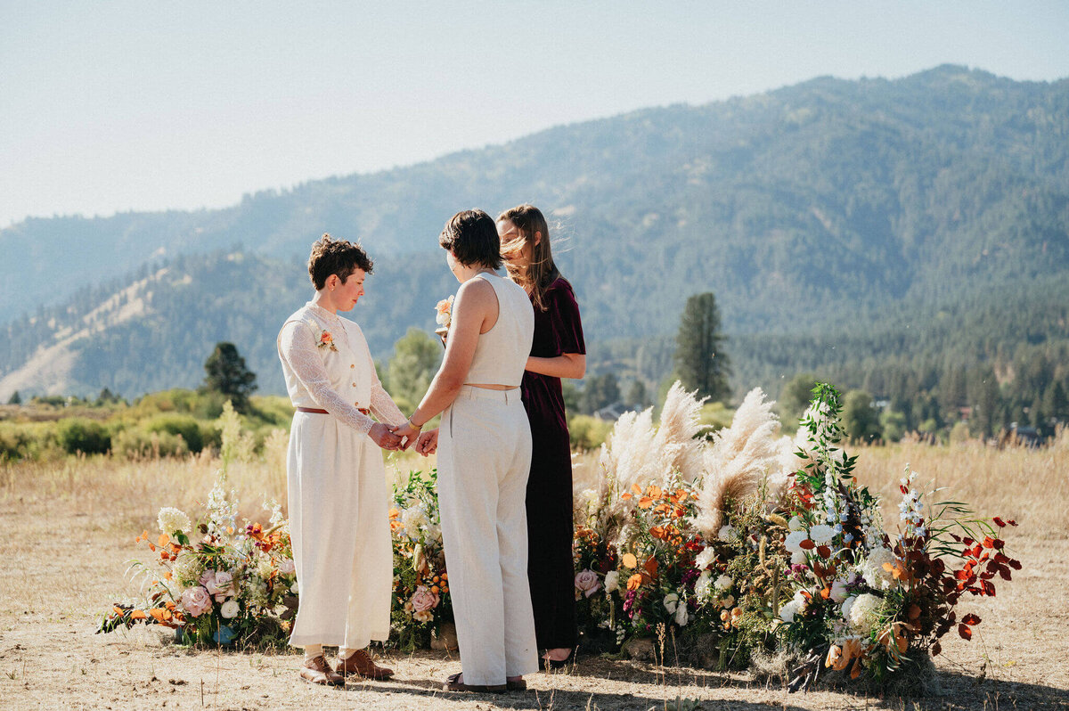 A couple exchanging vows at their outdoor wedding. 