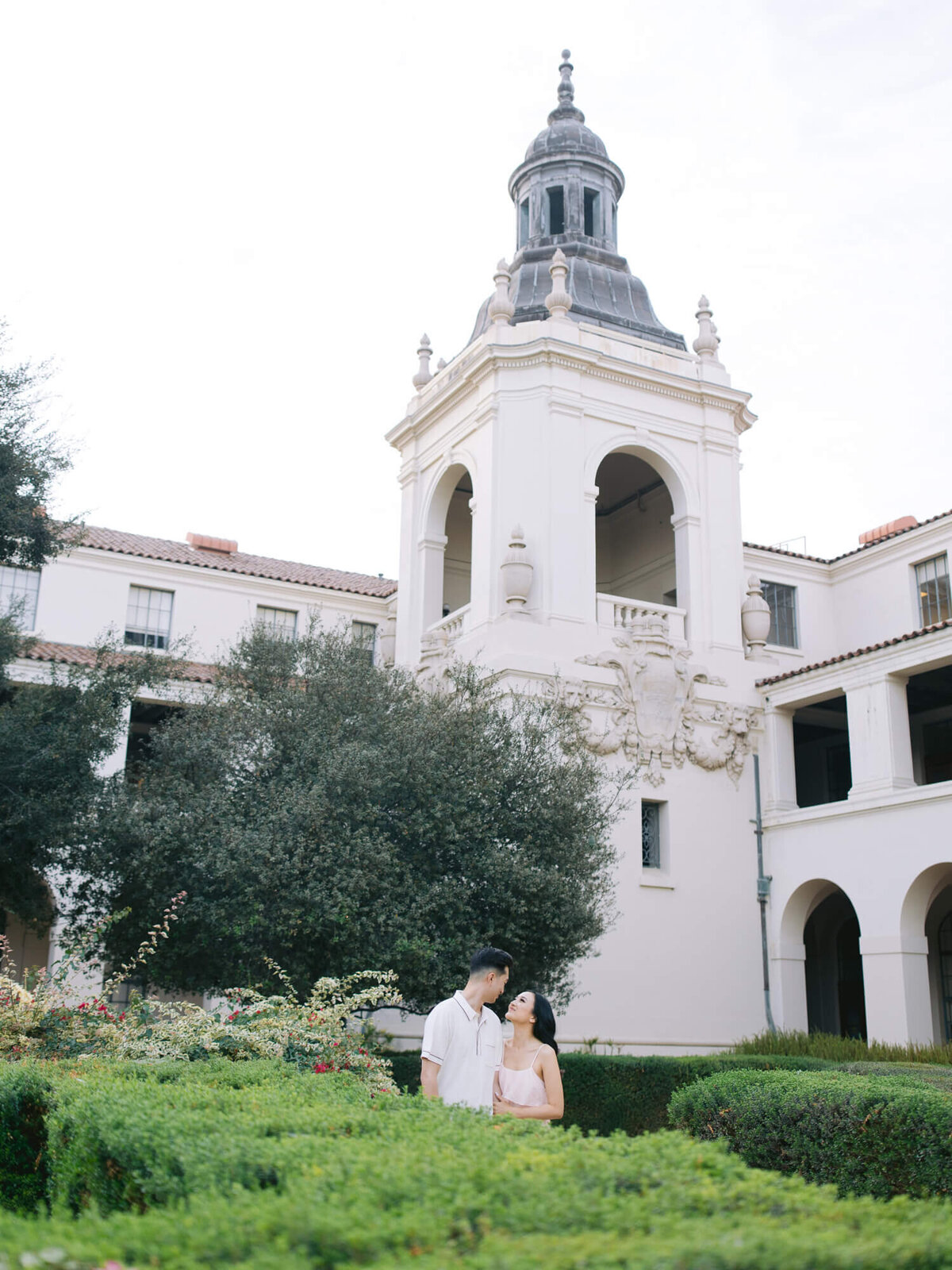 wide angle photo of couple and pasadena city hall tower