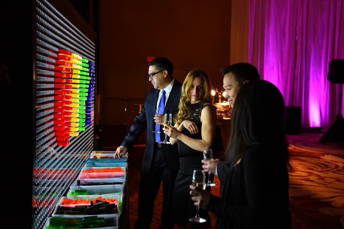 Attendees interacting with a colorful LED wall at a corporate event in Toronto, adding a creative touch to the evening