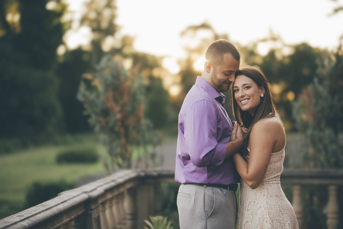 Couple smiling during sunset engagement photo at Natirar Park in Peapack Gladstone New Jersey