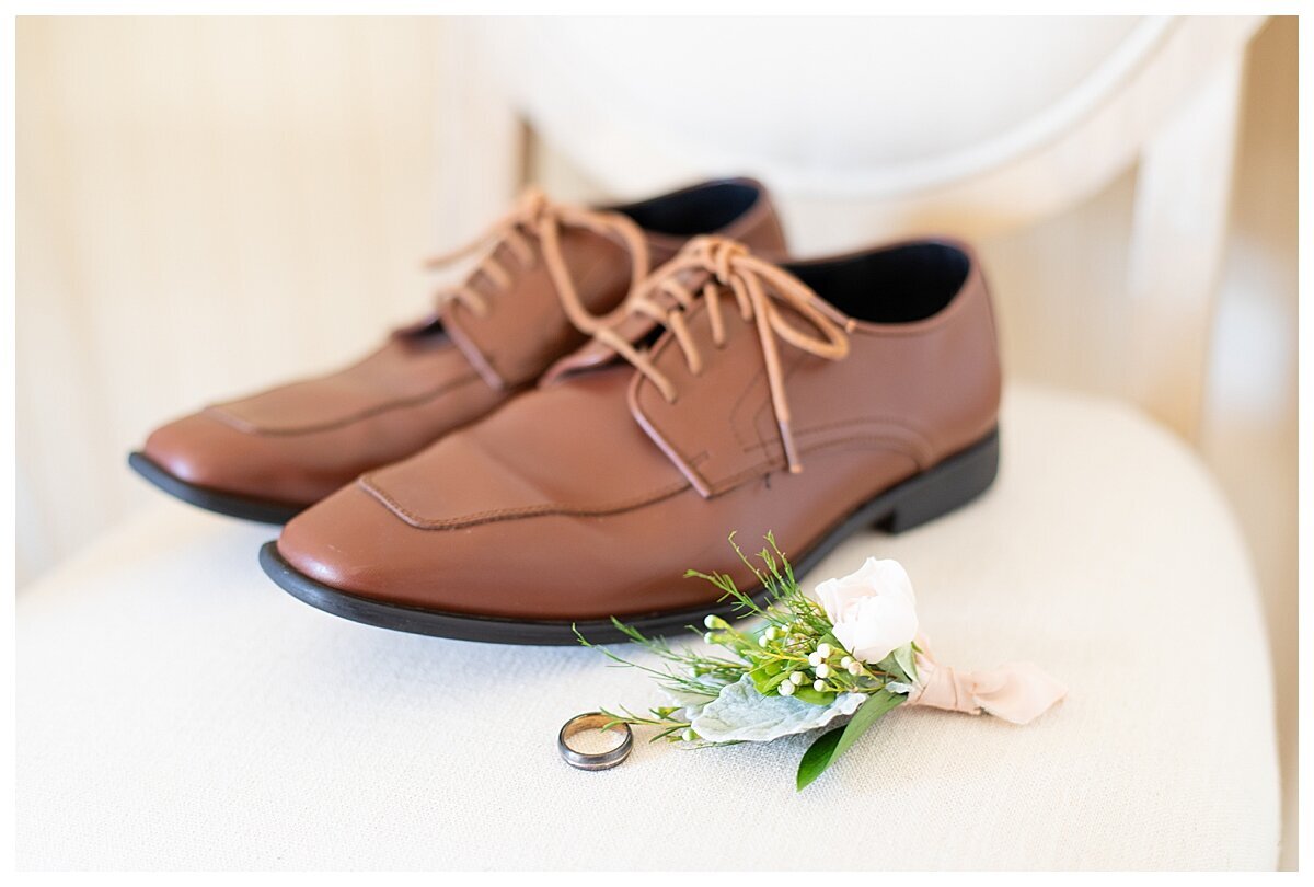 Groom's shoes and boutineere  on chair