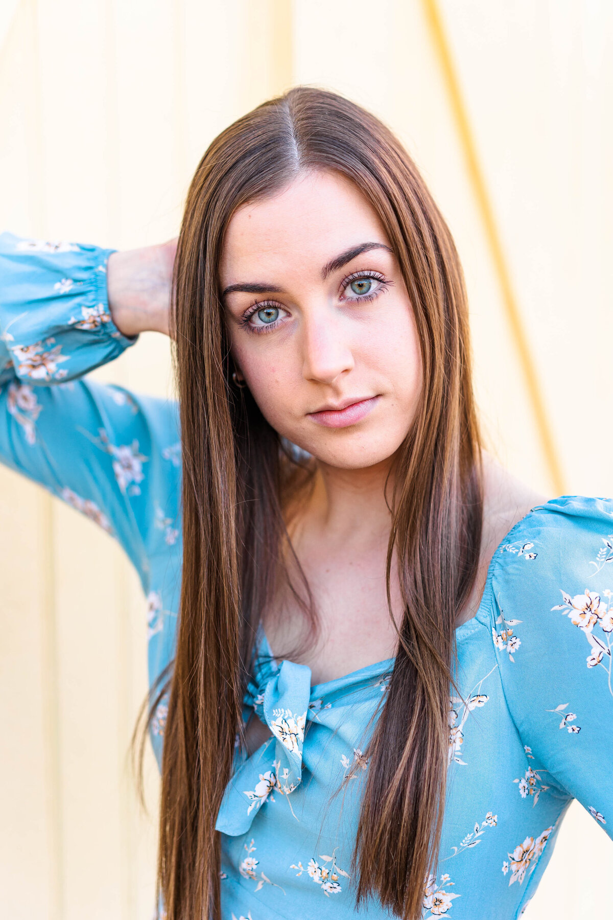 Senior girl in blue dress looking at camera