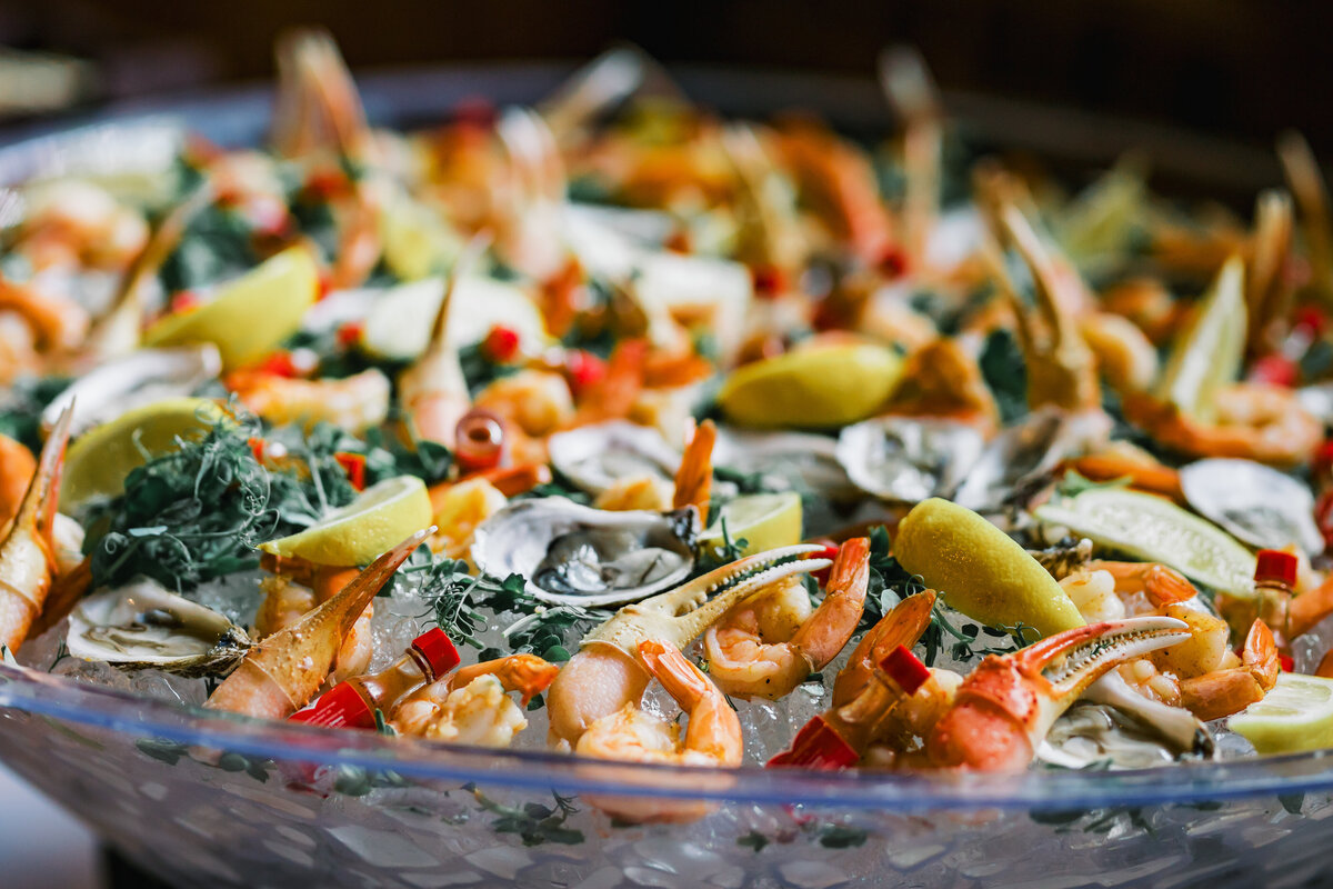 Luxury seafood display featuring shrimp, oysters, crab claws, and fresh garnishes at a wedding reception at Old Edwards Inn in Highlands, North Carolina.
