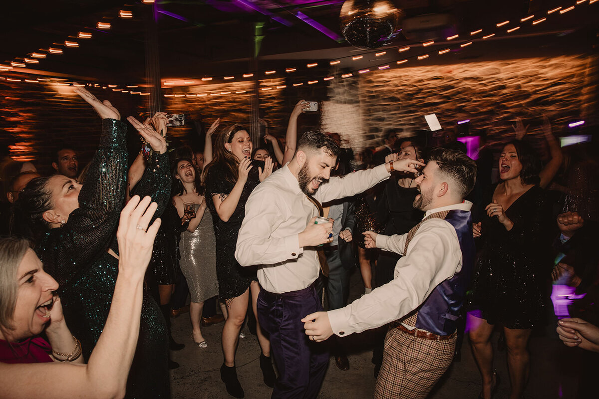 Wedding guests dancing at a reception 