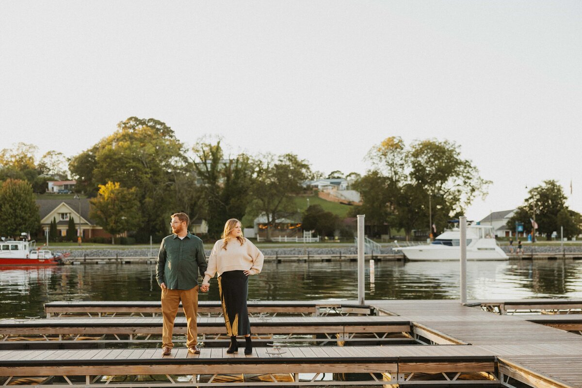 couple holding hands looking in opposite directions