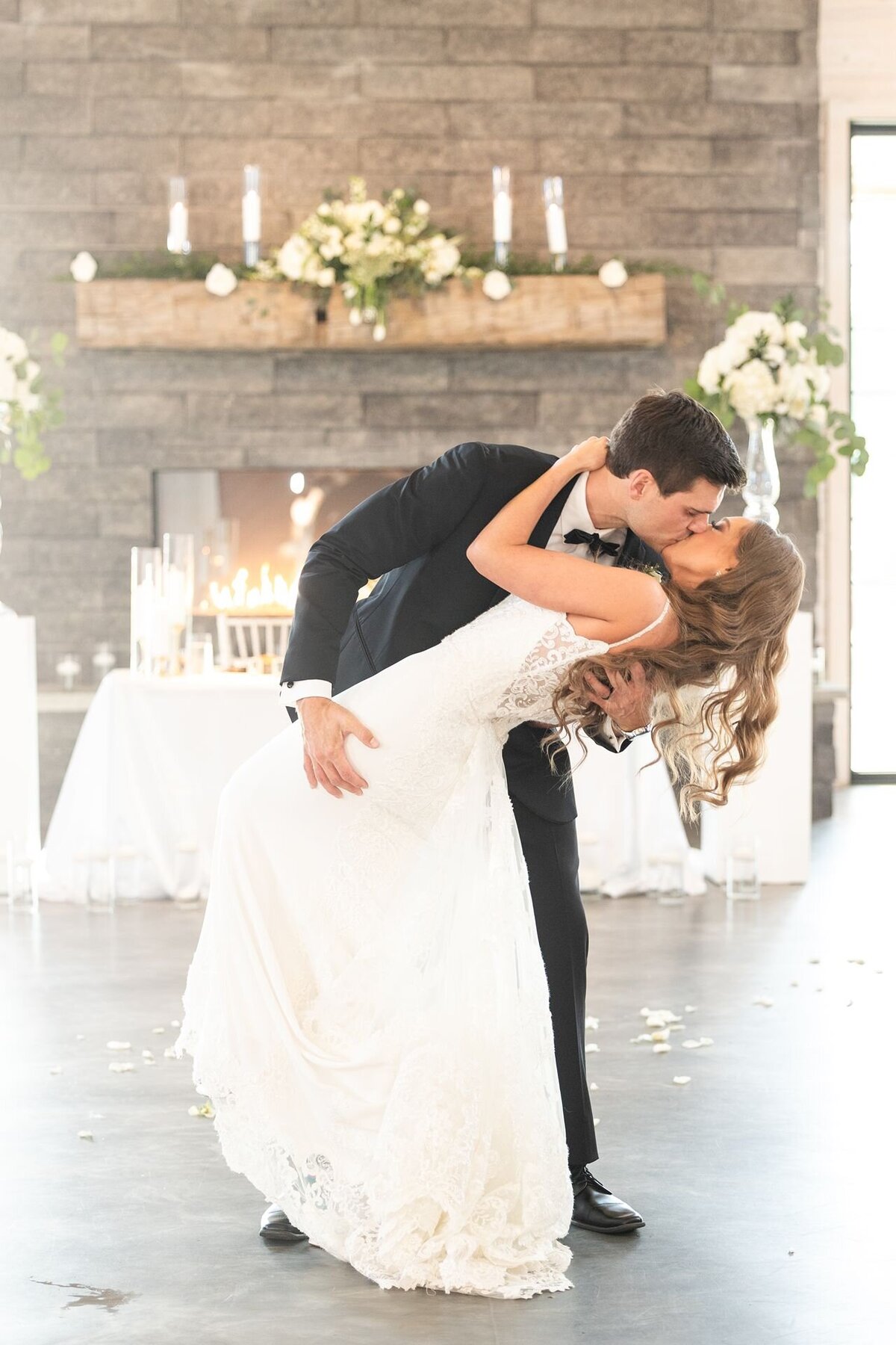 Groom dips his bride for a kiss