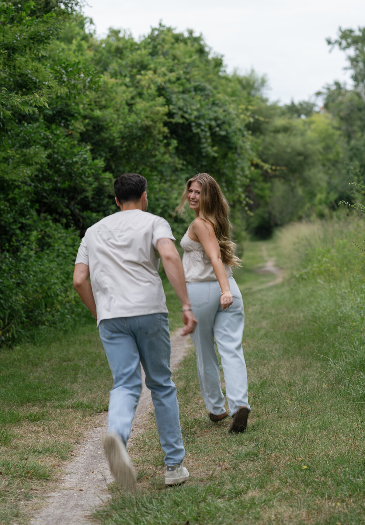 Couple running in field taken by florida engagement photographer, Shelby Ann Photos