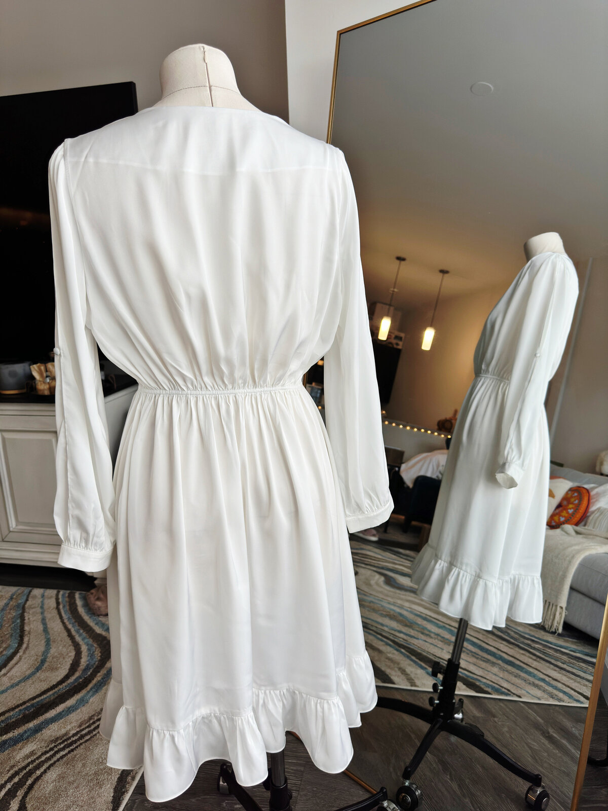 Bride wearing elegant custom robe with split arms and cinched waist
