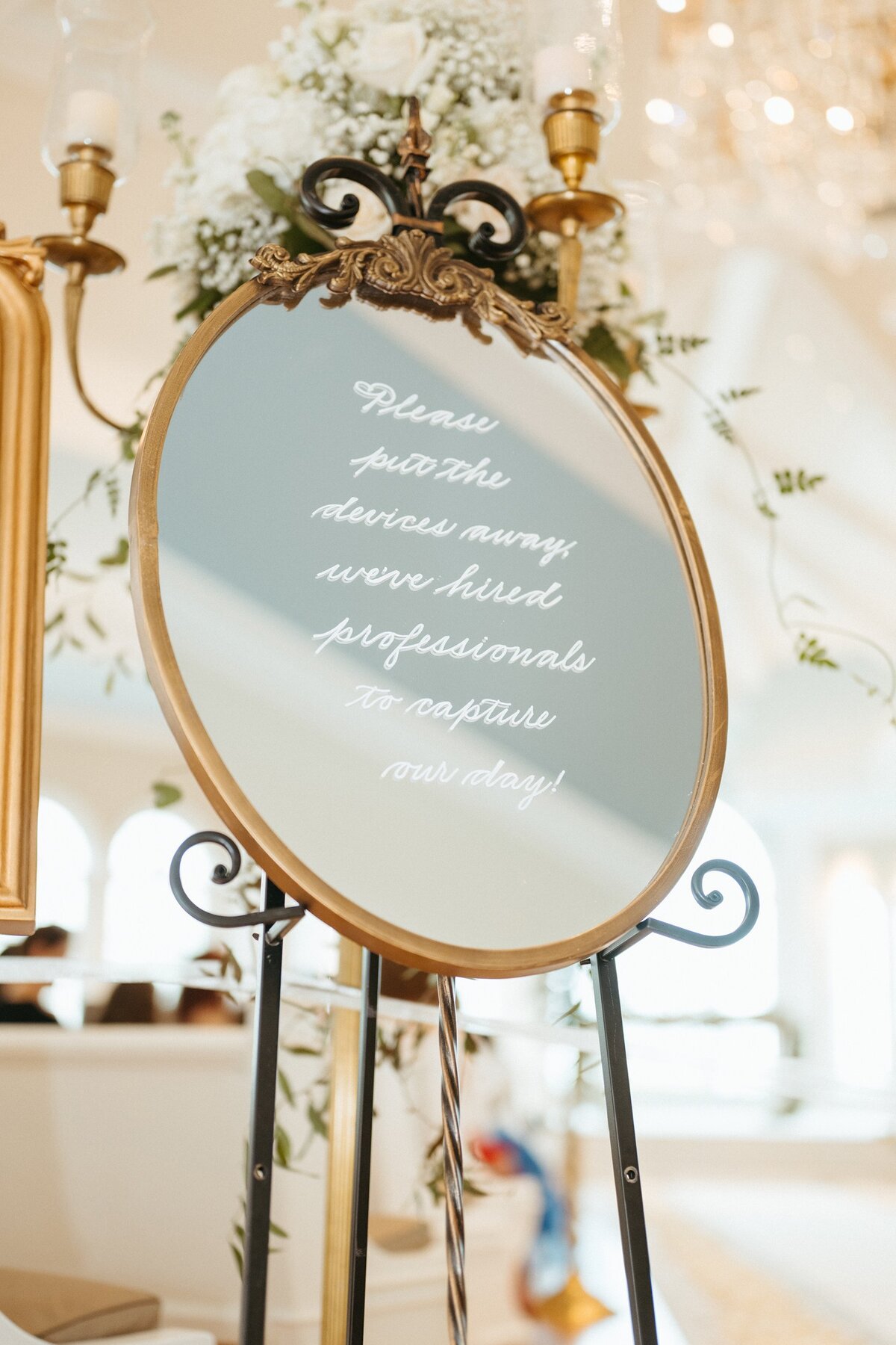 Medium oval mirror with ornate ornament on top and calligraphy
