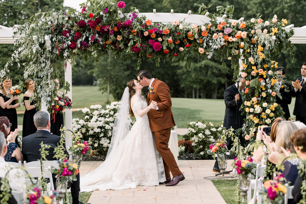 First kiss under floral arch