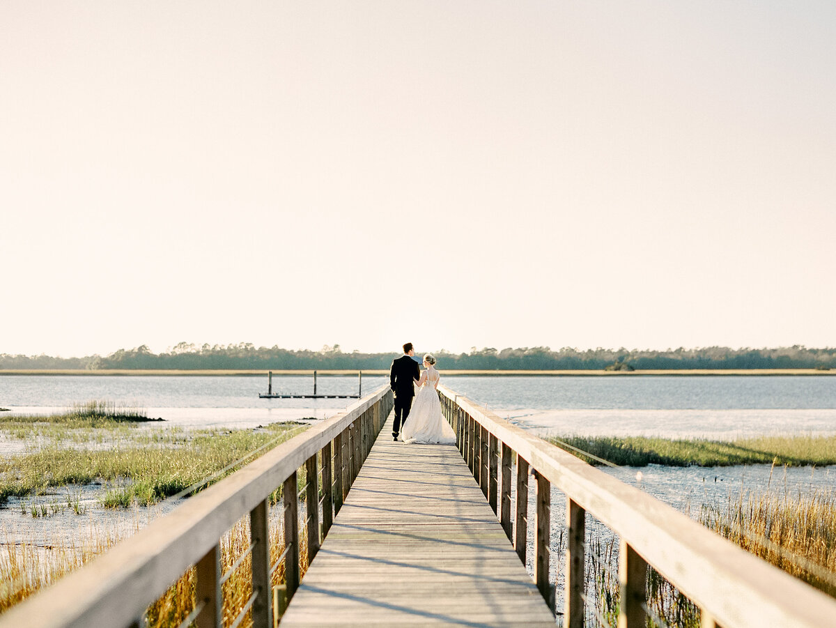 Bride and groom on wooden dock on river at Charleston Wedding
