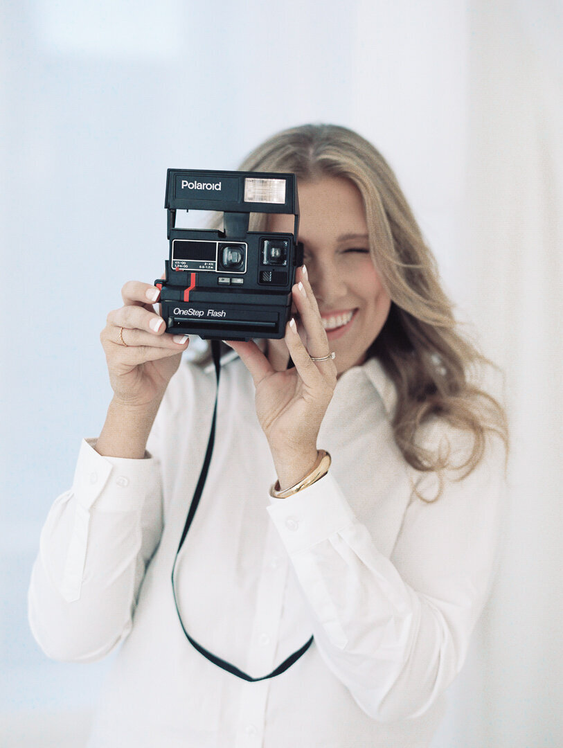 photographer holding polaroid camera indianapolis brand session