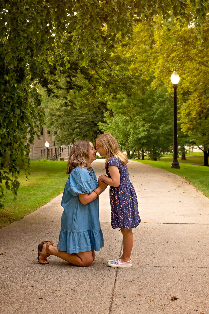 Mom crouches to embrace daughter at Kent State University