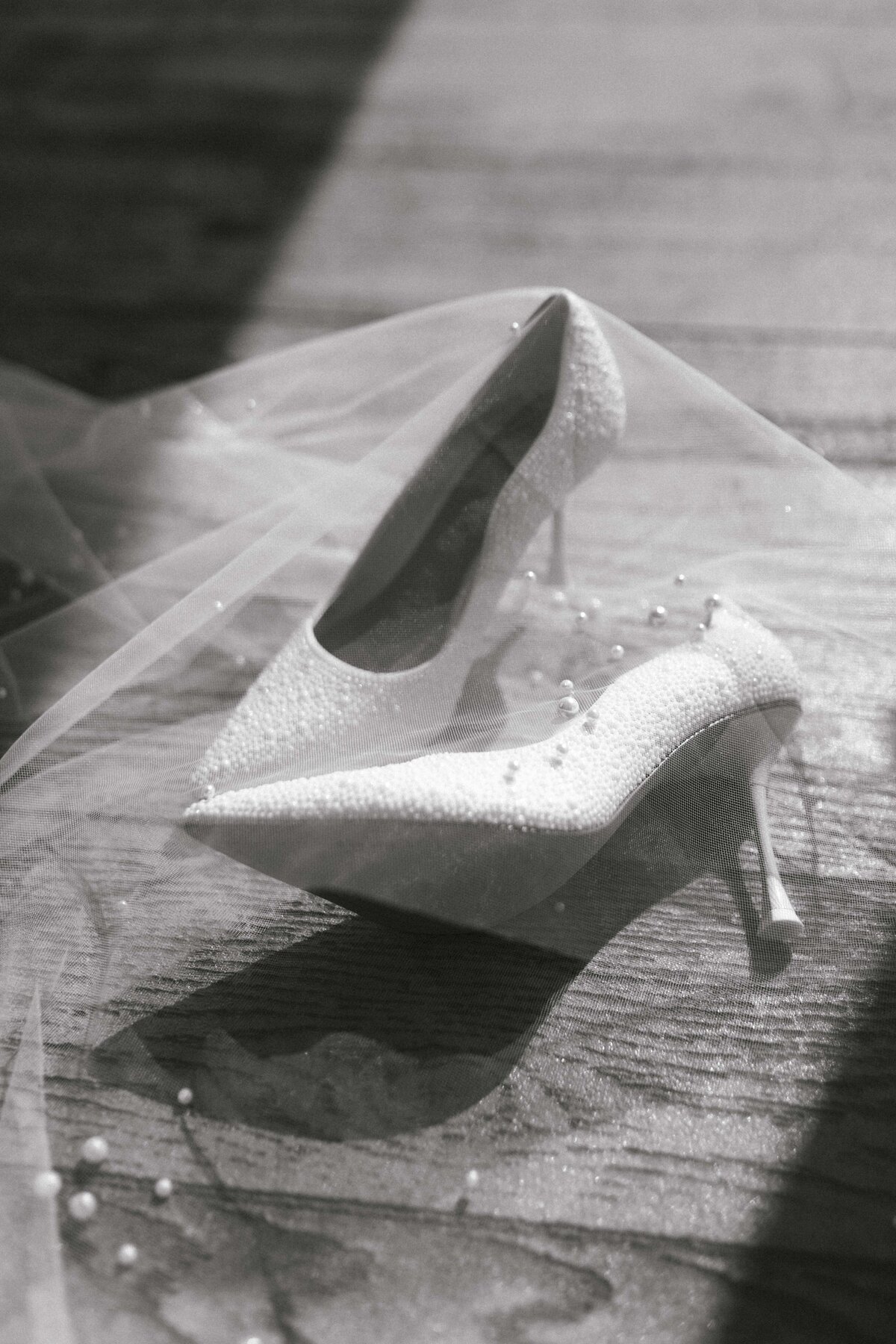 Black and white bridal shoe details with veil at outdoor wedding venue in Springfield Missouri