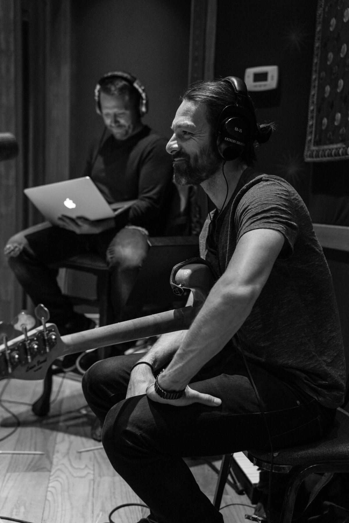 Geoff Sprung playing bass guitar in recording studio