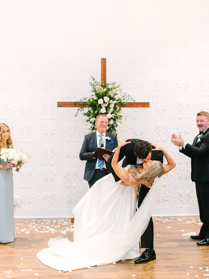 Bride and groom kissing in church by wedding planners in chicago