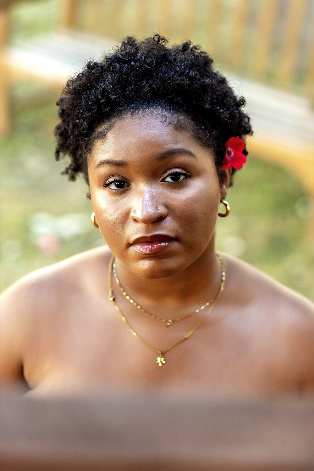African American woman with natural hair and red flower in hair