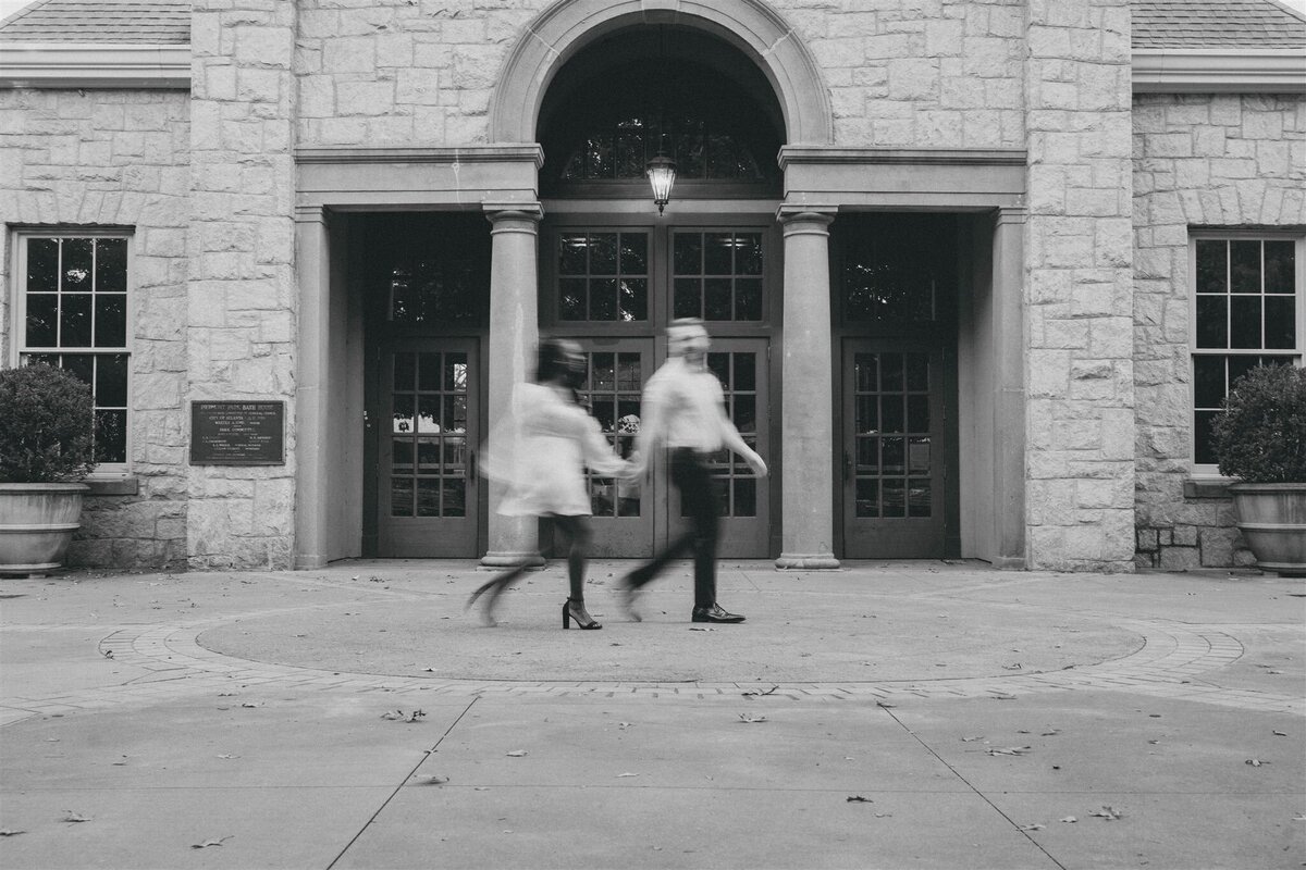 man and woman holding hands while walking