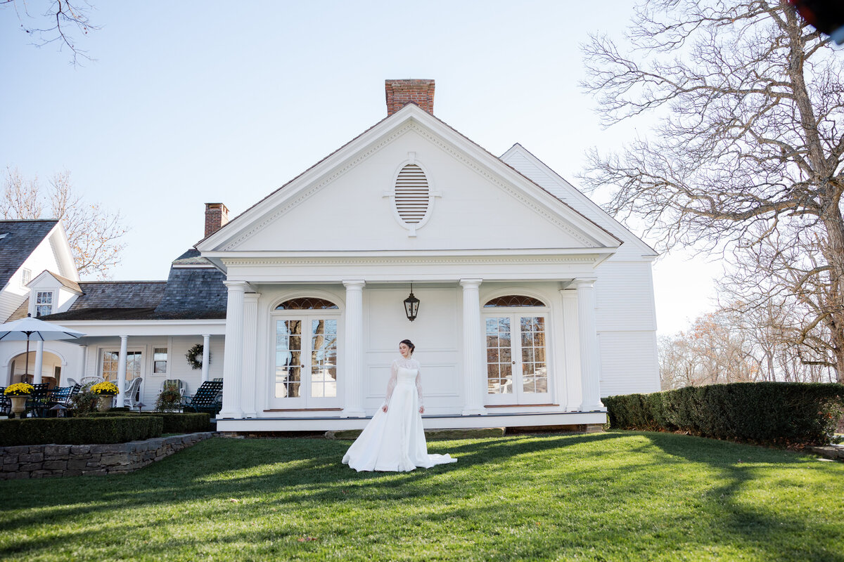 A bride in her dress behind Smith Farm Gardens in Connecticut.