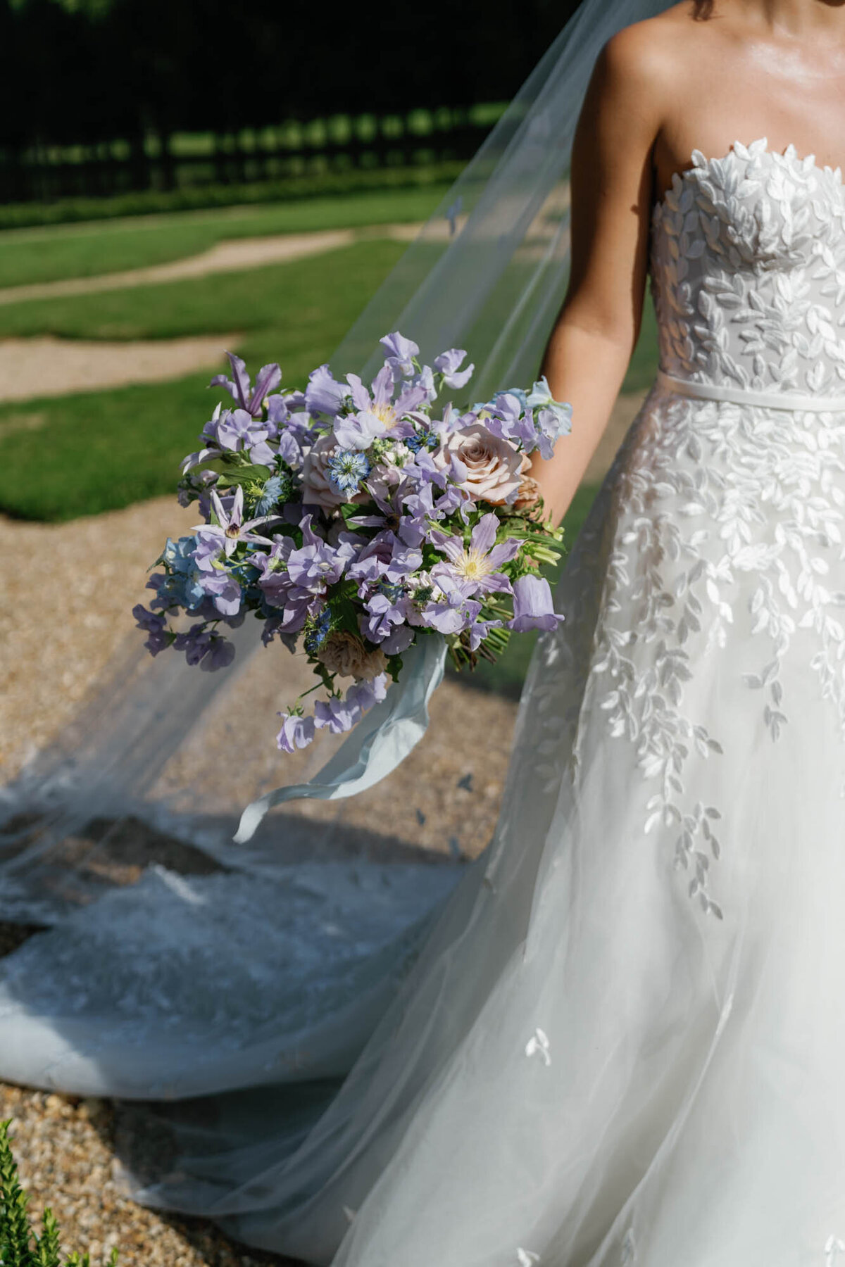 the bride holding her  lilac wedding bouquet