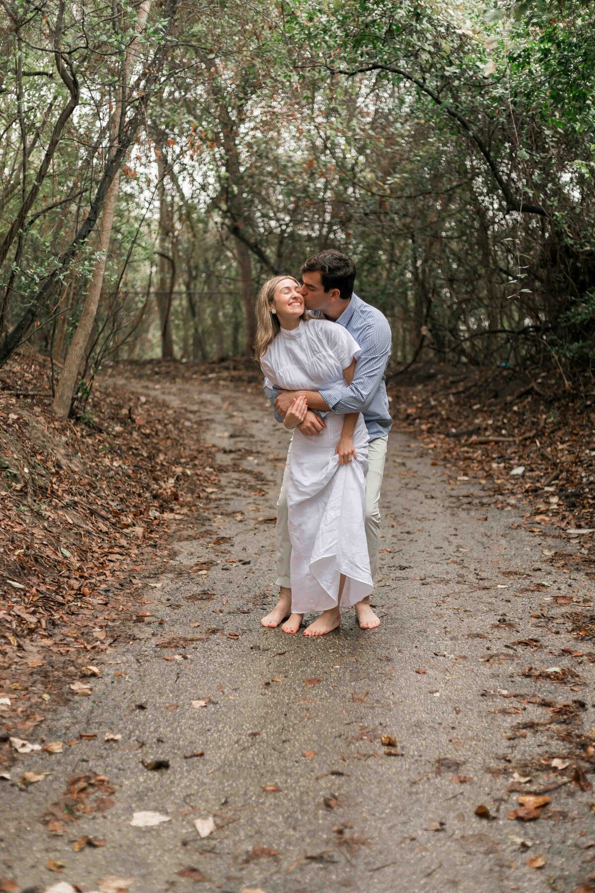 Allyson Blankenburg photographs couple as they play and hold onto each other in the rain.