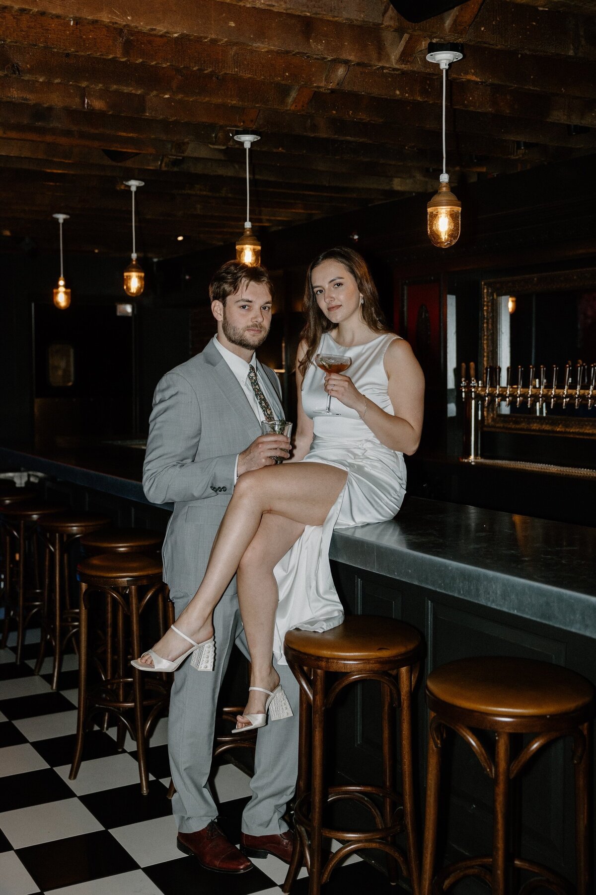 engaged couple sitting on bar