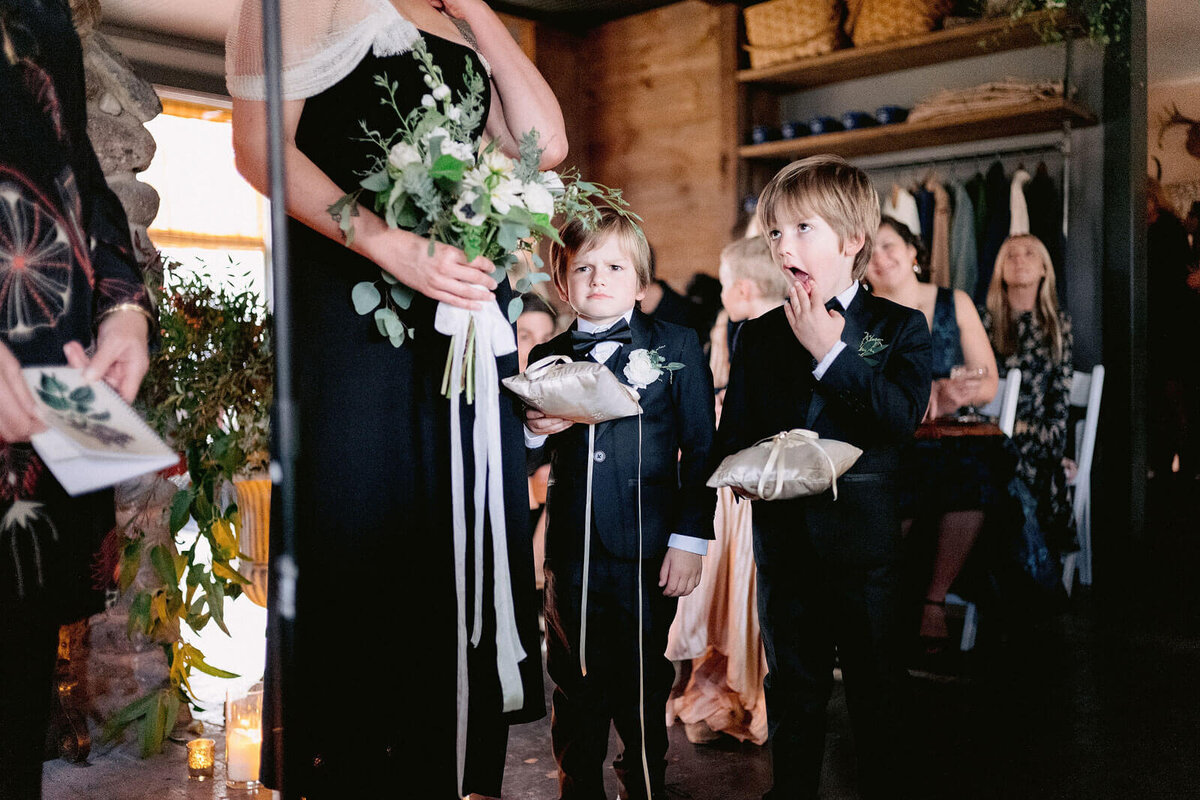Two cute ring bearers are waiting for their turn in Foxfire Mountain House, New York. Wedding Image by Jenny Fu Studio