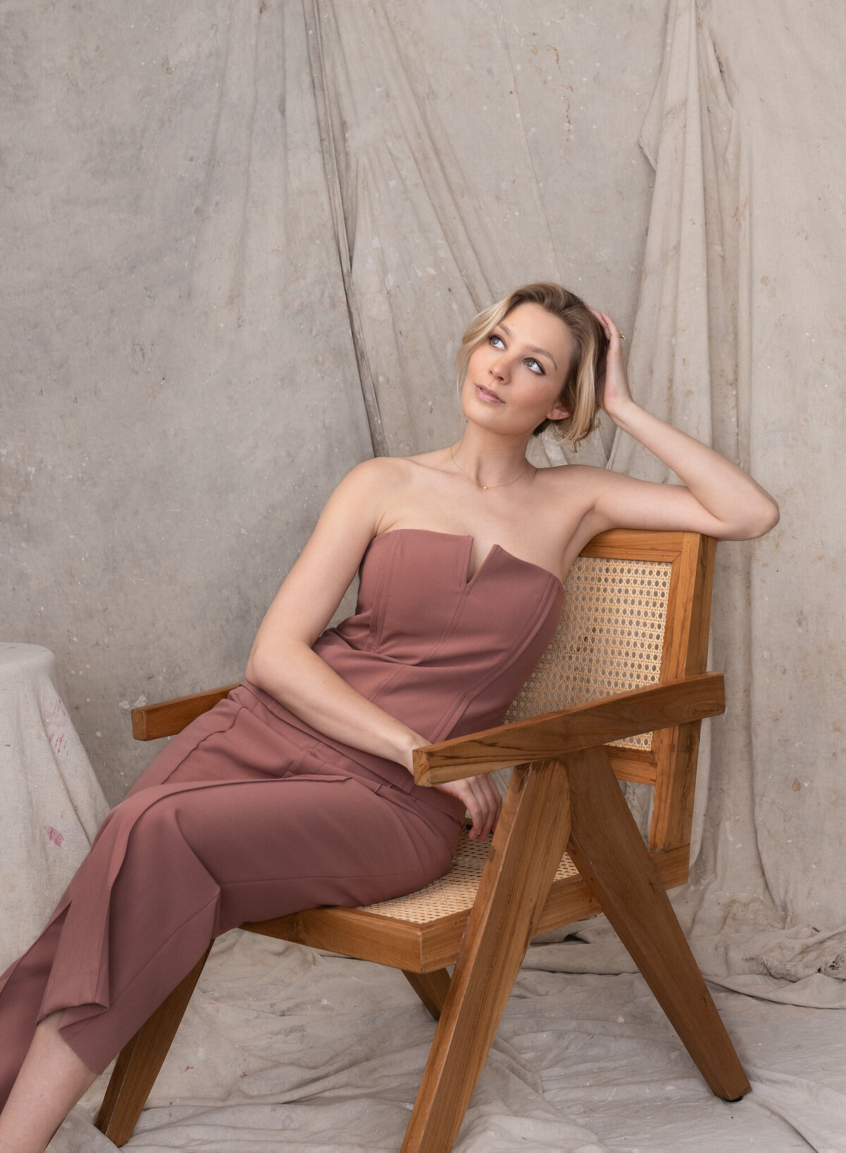 female-posing-wooden-chair