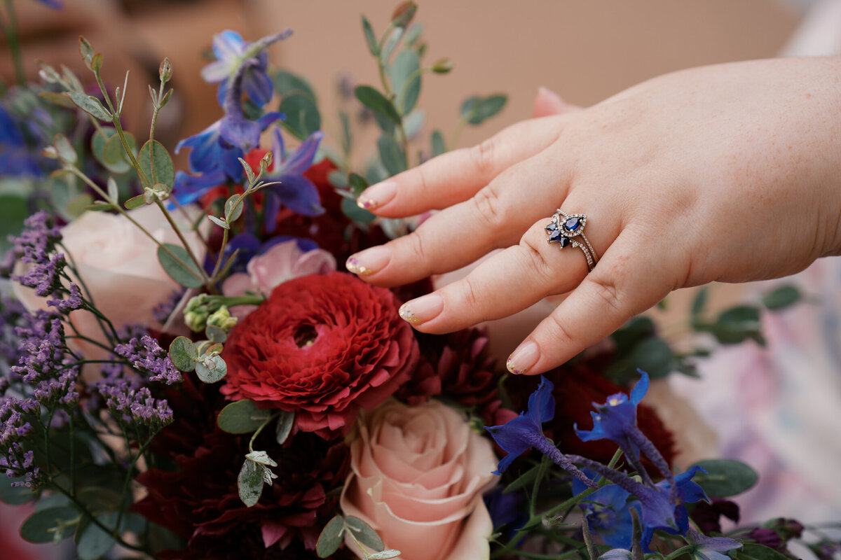 bride-gold-fleck-nails-sapphire-ring-bouquet