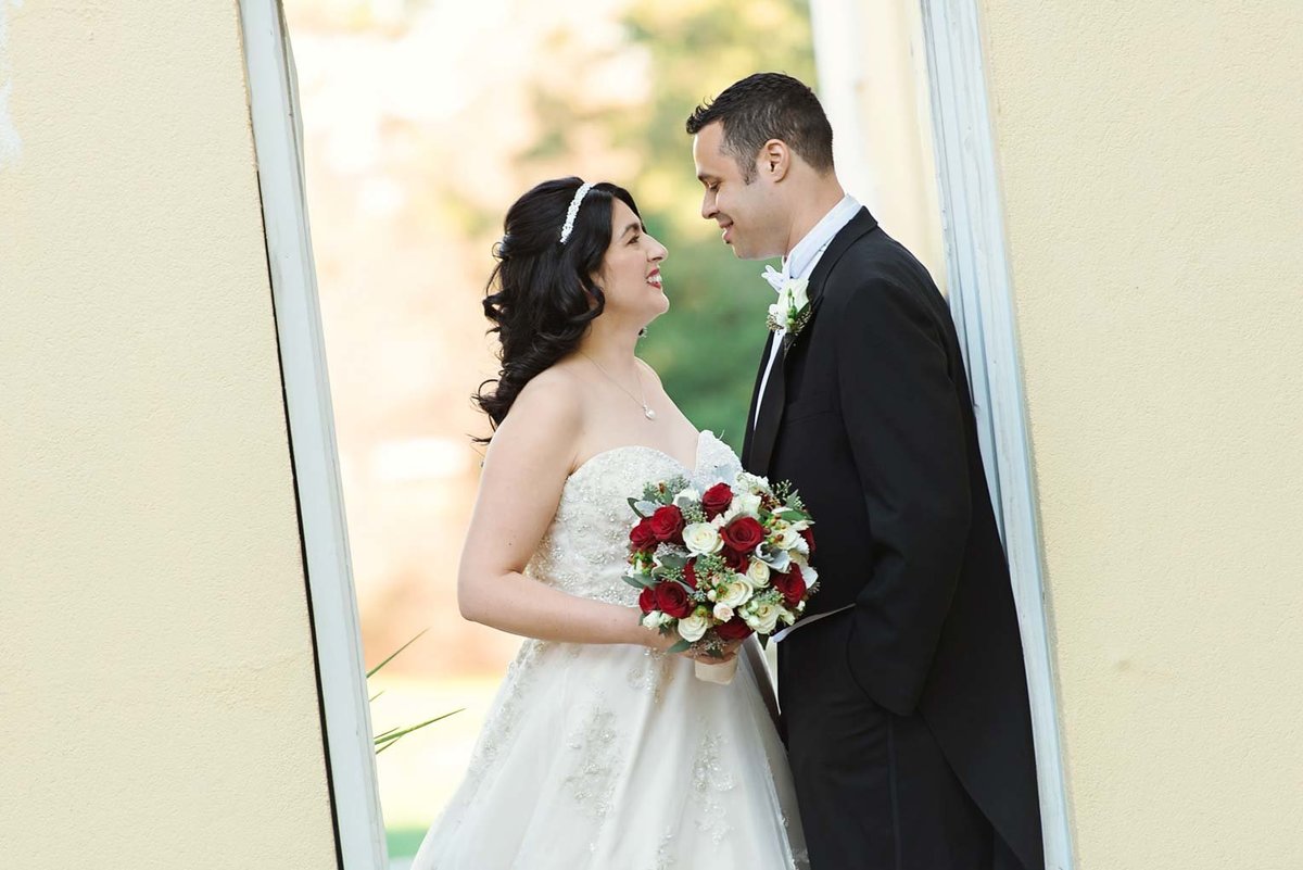 Bride and groom looking at each other outside The Mansion at Oyster Bay