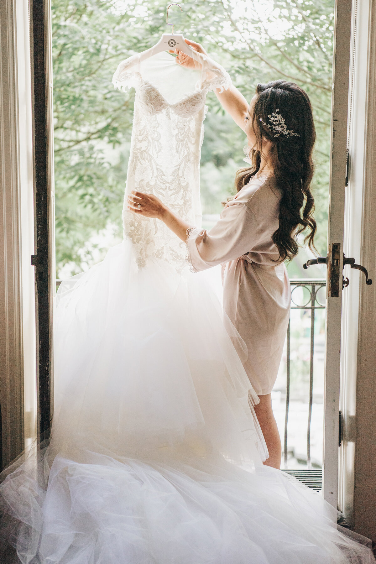 Bride holding up beautiful wedding dress
