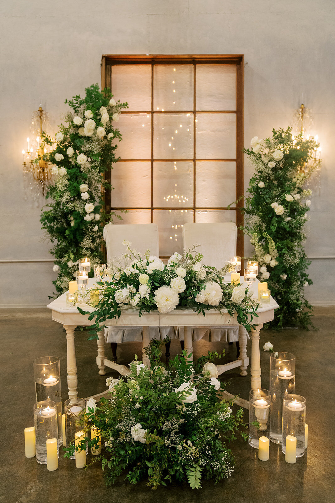 sweetheart table flowers with candles at willow ballroom