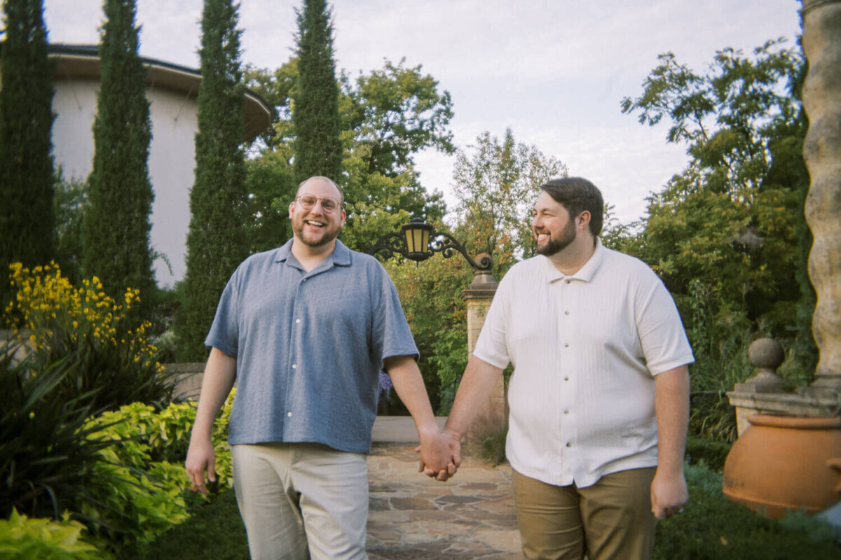 men-holding-hands-laughing