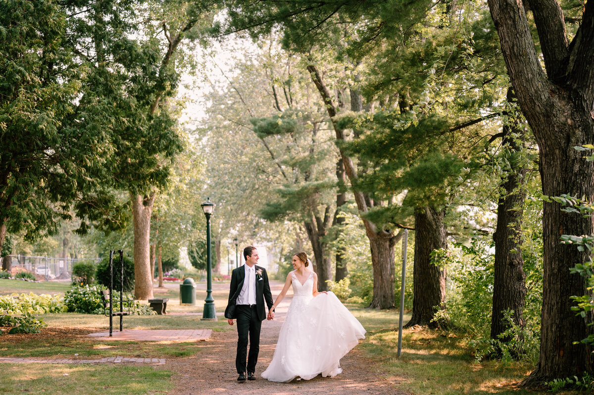 bride and groom walking while holding hands