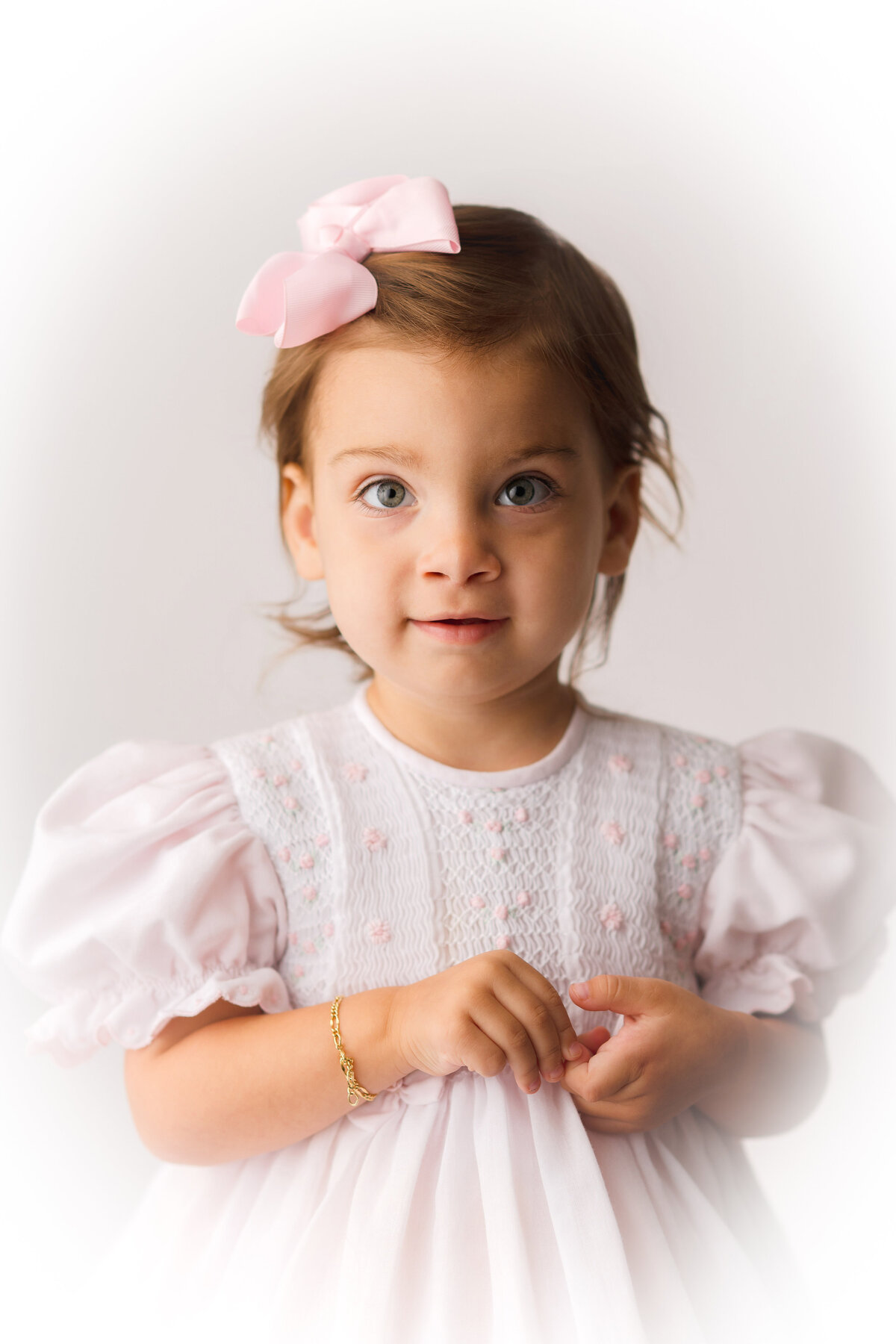 Little girl smiles at the camera during Heirloom Portrait Photography Session in Charleston, SC Photo Studio.